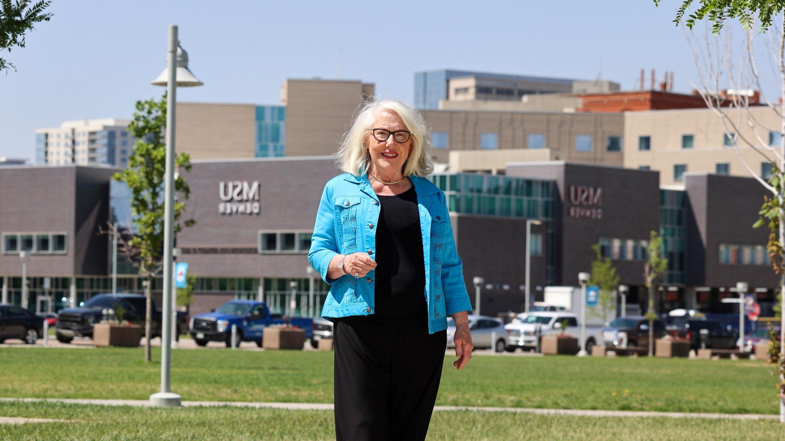 Barb Grogan standing near the Tivoli with the SpringHill Suites in the background
