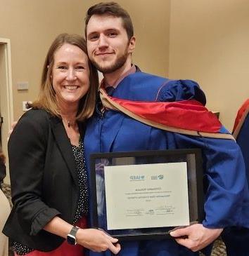Christopher Ristuccia and Jo Erven with IIA Certificate at Grad Hooding May 2023